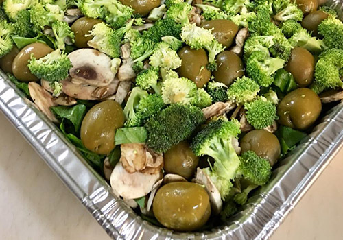 tray full of broccoli and olives